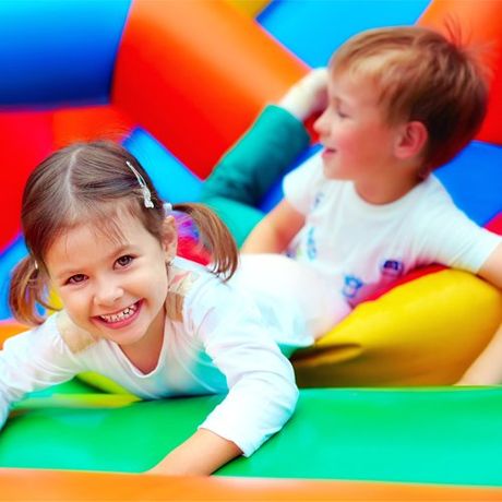 Playing on Inflatable Playground — Cheyenne, WY — The Backyard Child Care Center
