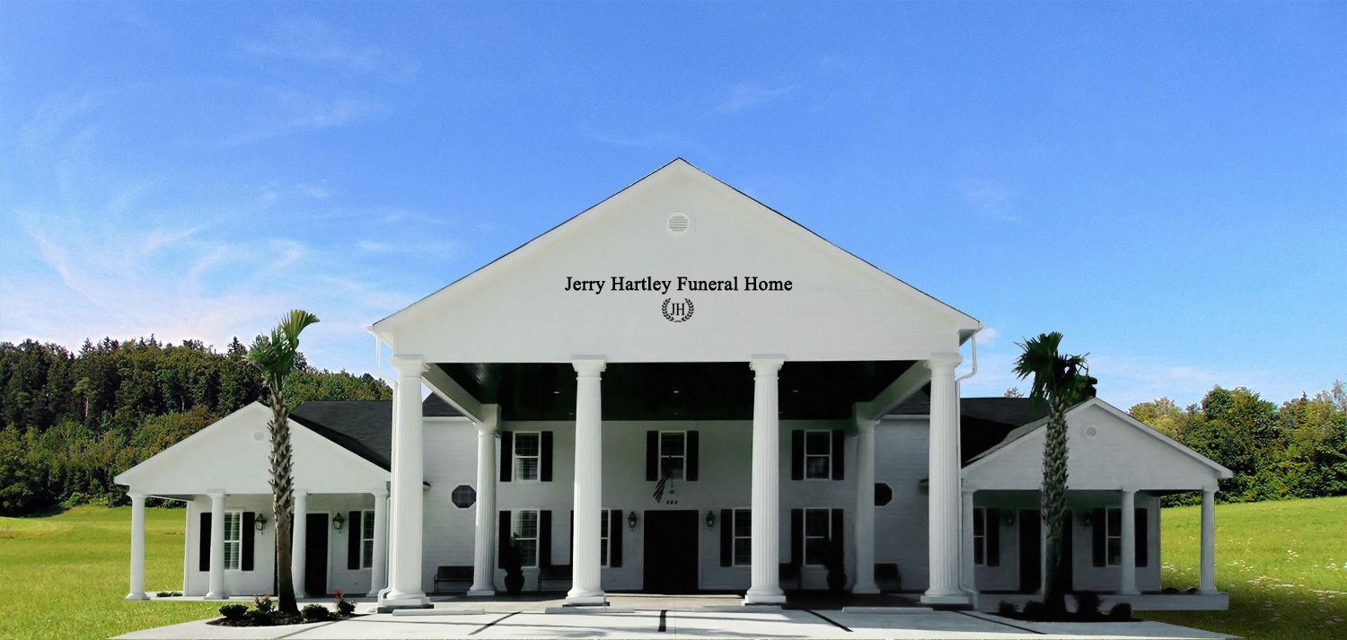 White building with large columns and a blue sky;