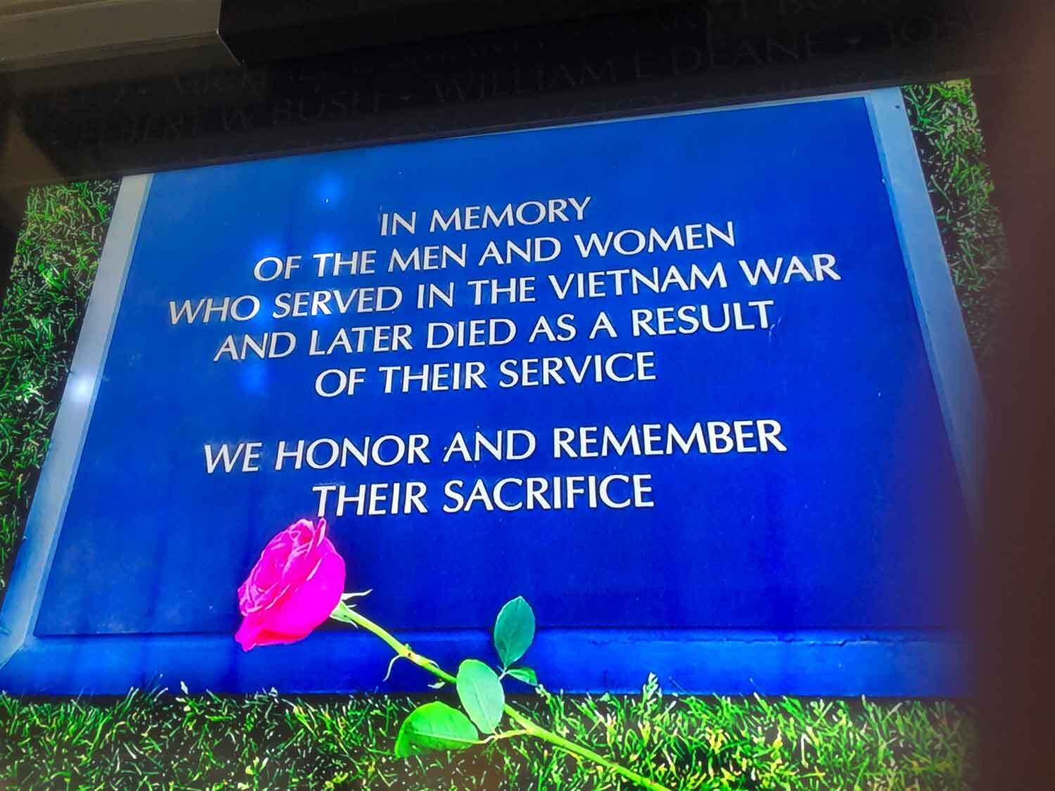 Blue memorial plaque with white text: