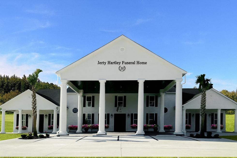 A large office building with a lot of windows on a sunny day.