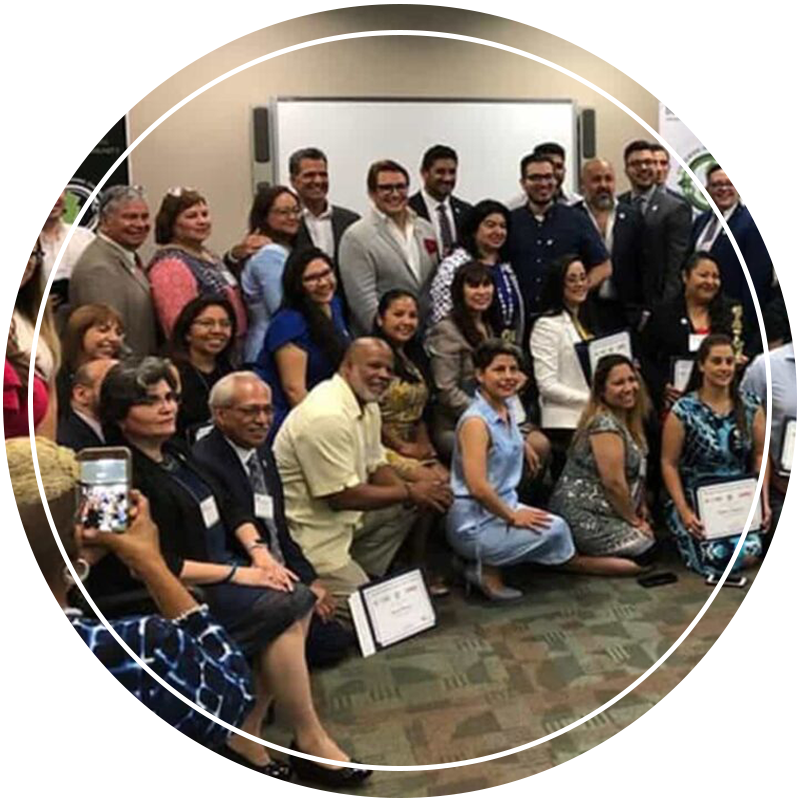 Michael R. Cohen — Eau Claire, WI — Cohen Law Offices Group of diverse people pose together in a room, many holding certificates. A whiteboard is in the background.