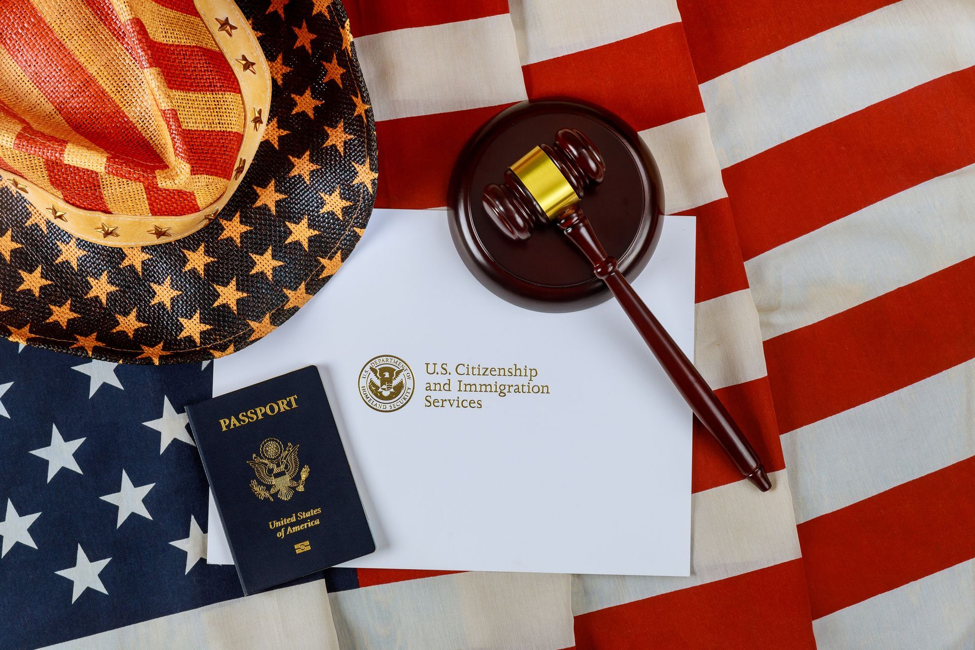 American flag, cowboy hat, gavel, passport, and citizenship document; concepts of law and patriotism.