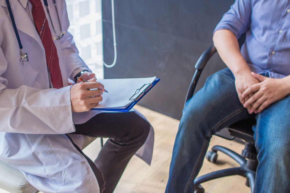 A Doctor is Talking to a Patient Who is Sitting in a Chair — Brisbane Upper GI Surgery in Chermside, QLD