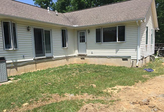 A white house with a gray roof.