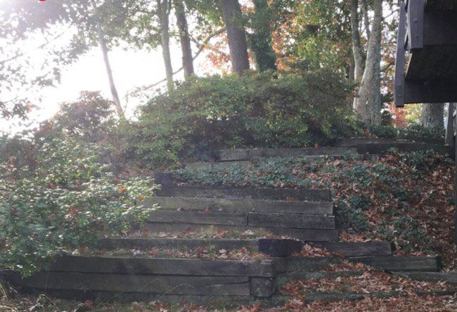 A set of wooden stairs leading up to a house.