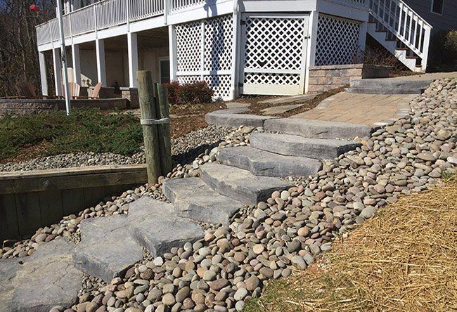 A house with stone steps leading up to it.