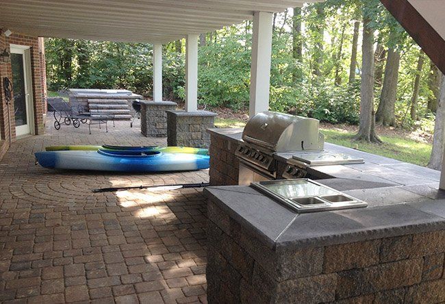 An outdoor kitchen featuring a grill..