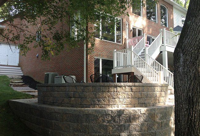 A brick house with a white deck and stairs