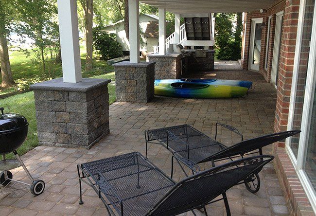 A patio with chairs , a grill.