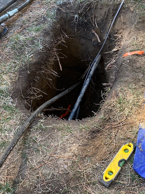 Installing 250 feet of primary wire for a streetlamp.