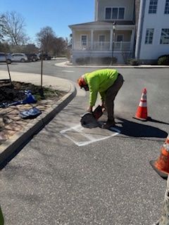 DVUC crew member cuts asphalt to create a location hole. 