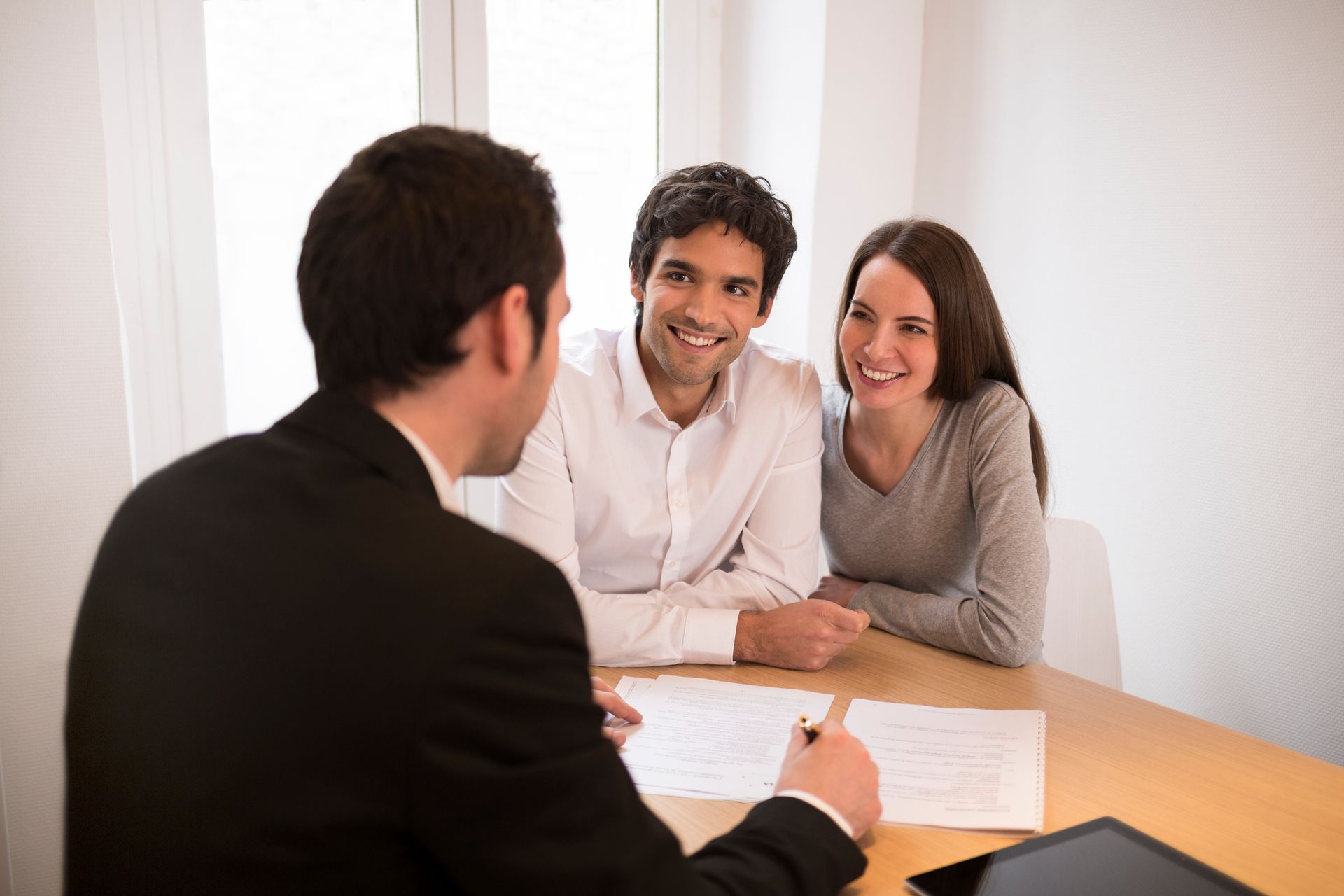 A young couple consulting their children's future with an experienced estate planning attorney.