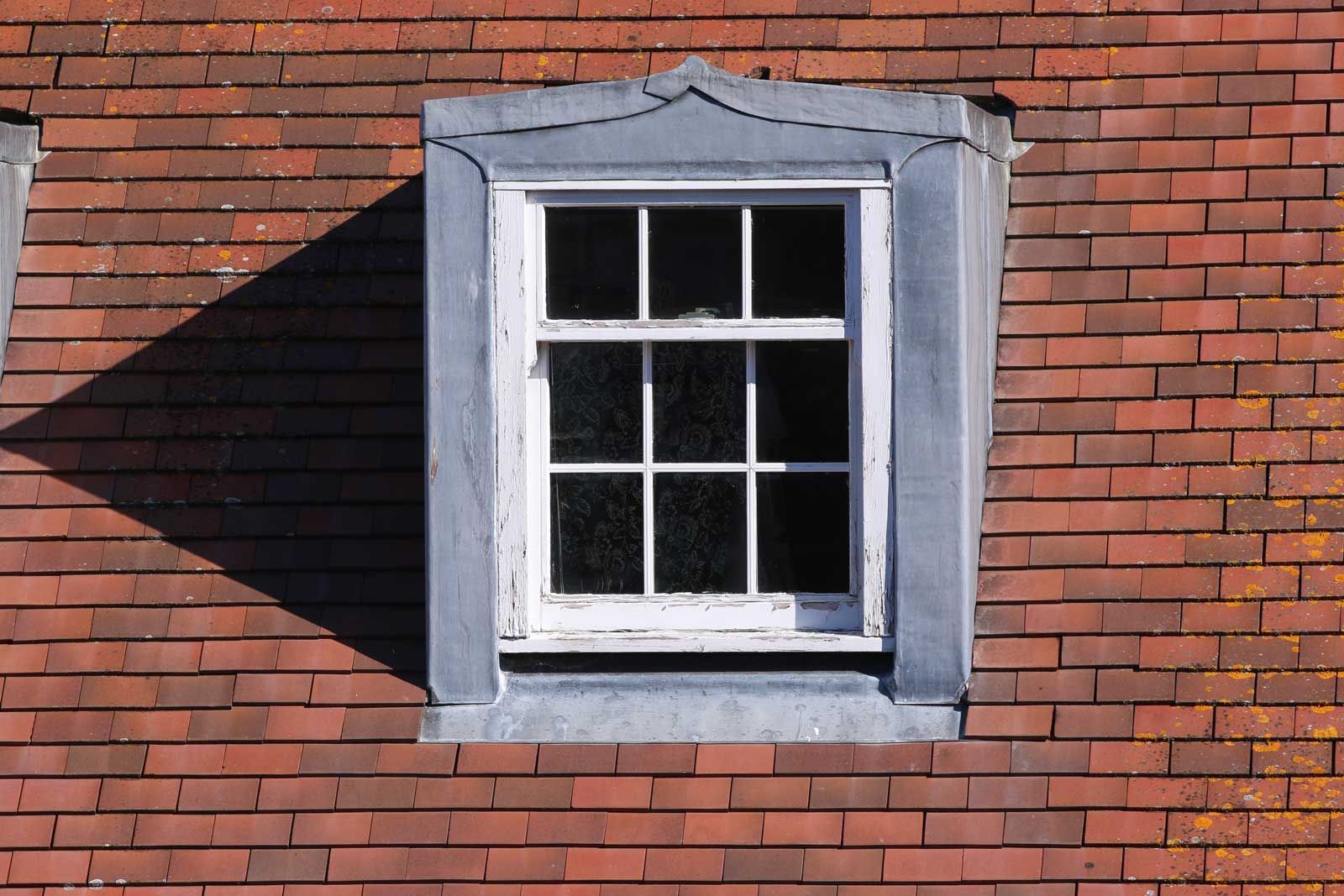 A close-up view of a house undergoing vinyl siding installation.