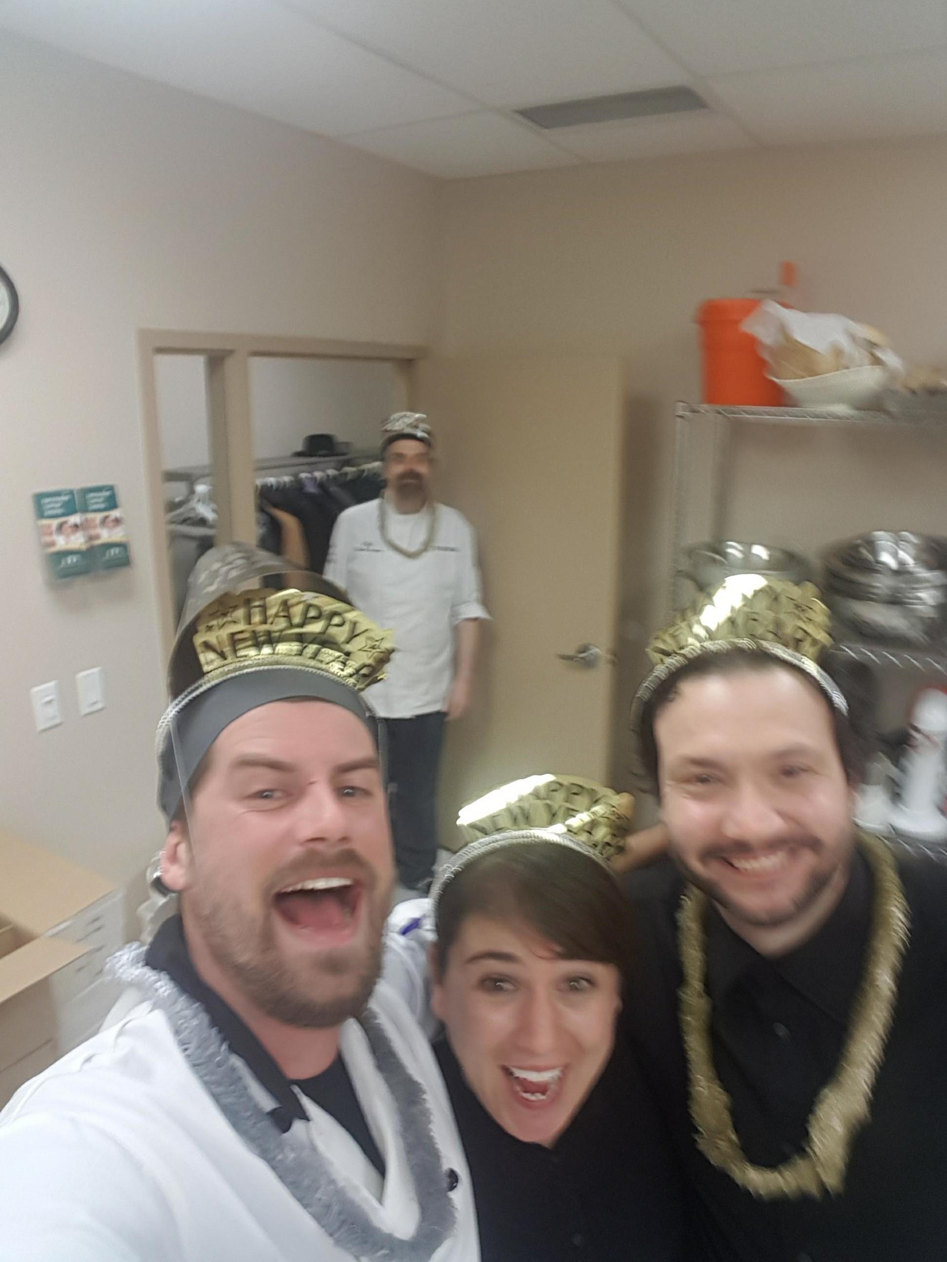a group of people wearing new year 's eve hats