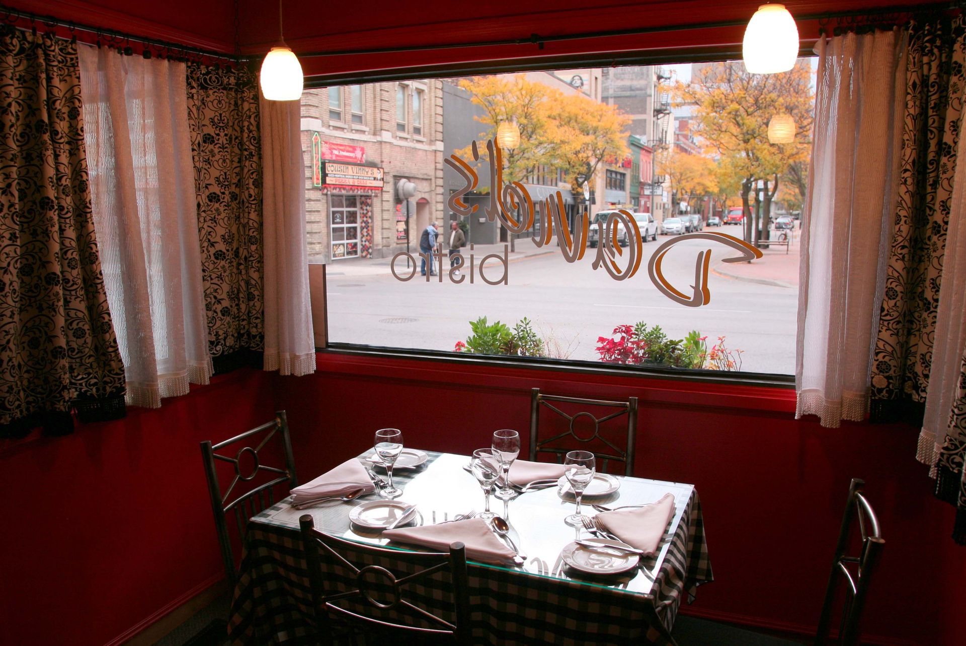a dining room with a table and chairs and a window with the letter g on it