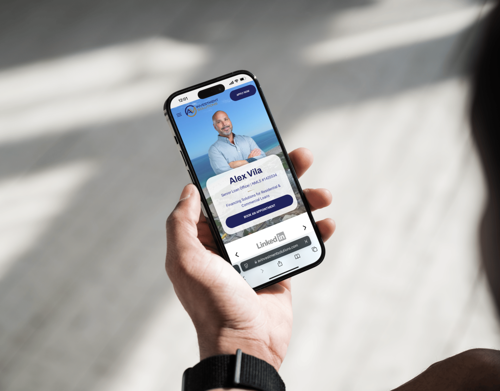 A person is holding a cell phone with a picture of a man on the screen.