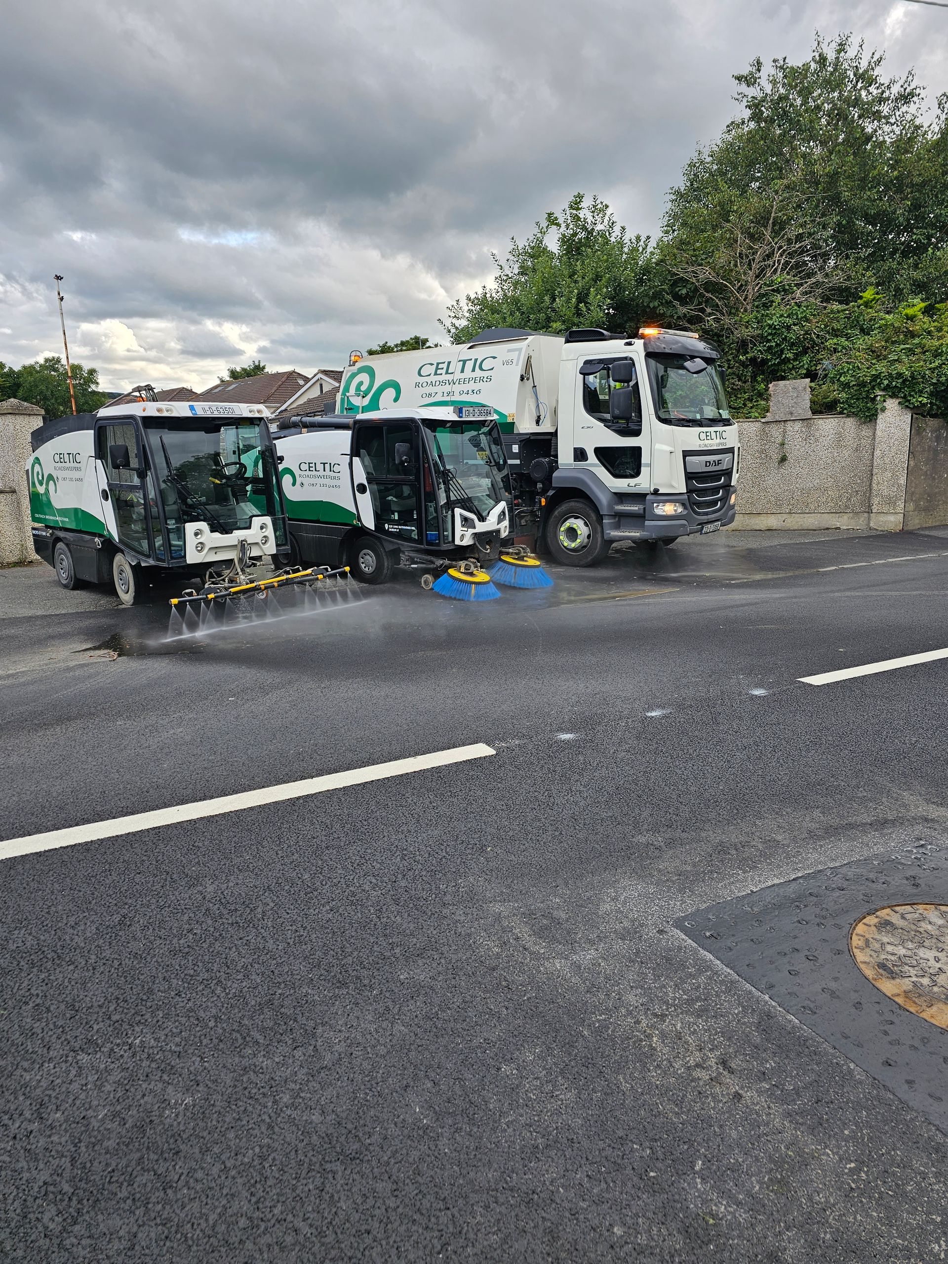 A couple of trucks are parked on the side of a road.