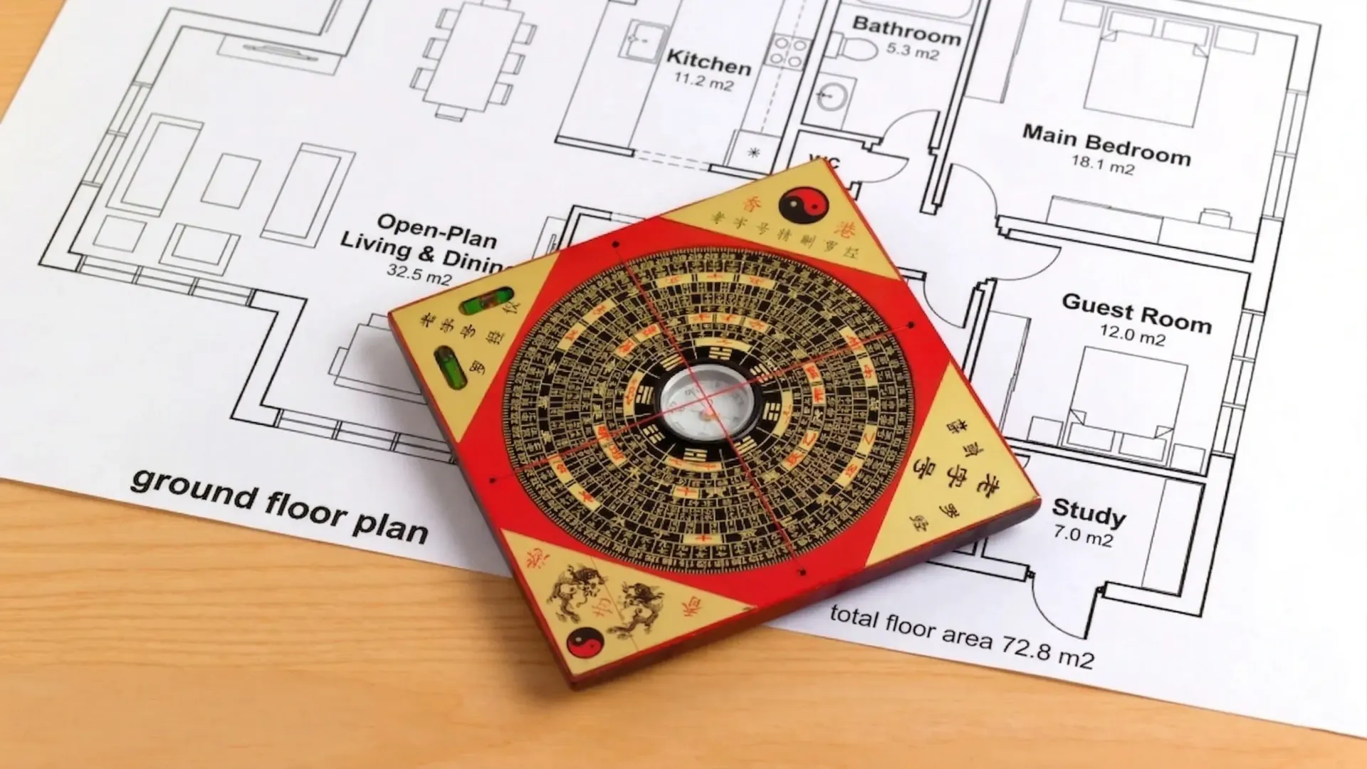 Feng Shui Luo Pan compass placed on a modern home floor plan during directional analysis