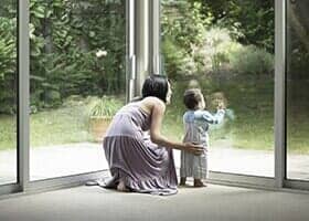 Mother and Son Looking Out Window - Residential and Commercial Glass Work in Oxnard, CA