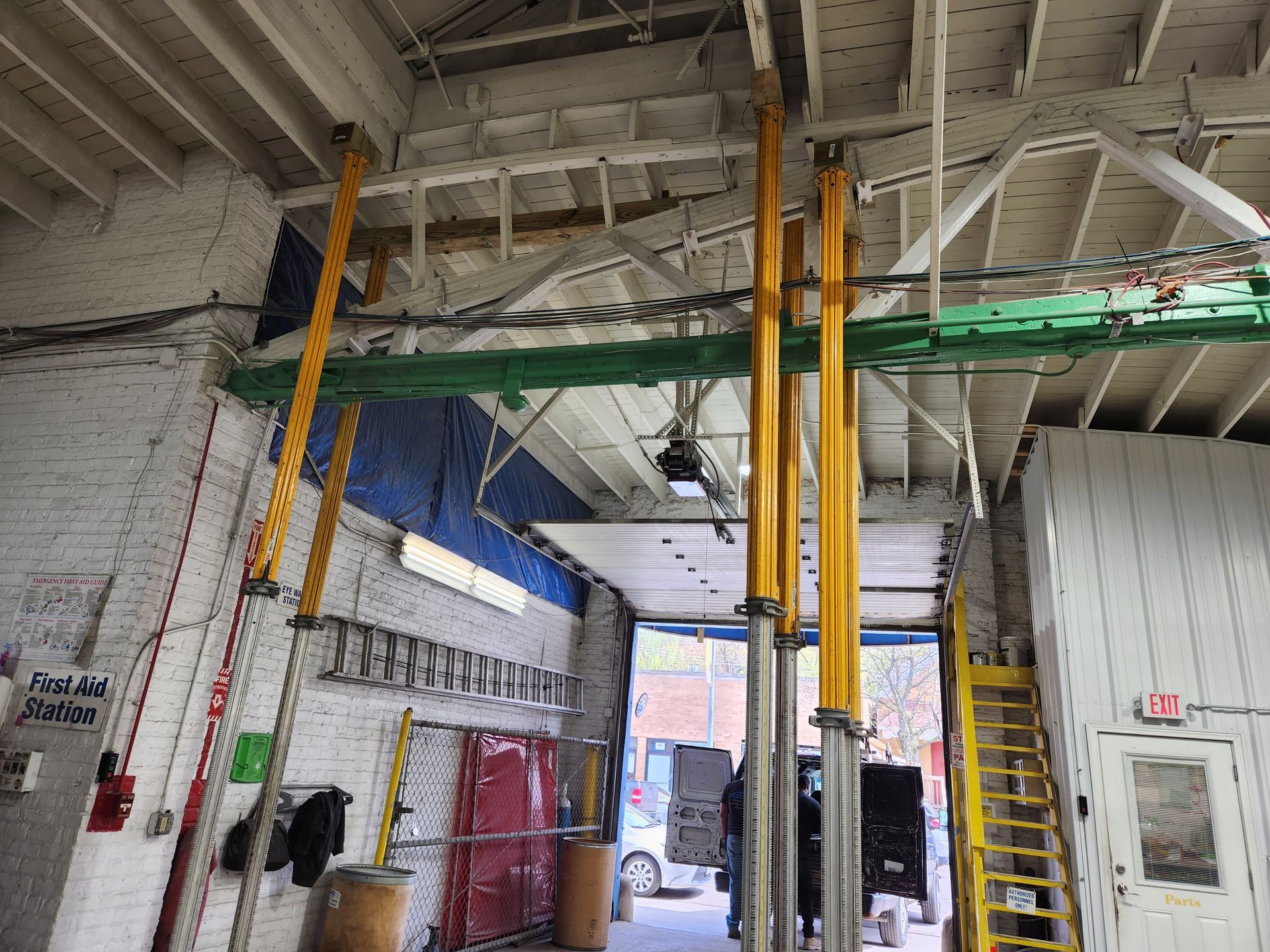 A garage with a ladder hanging from the ceiling.