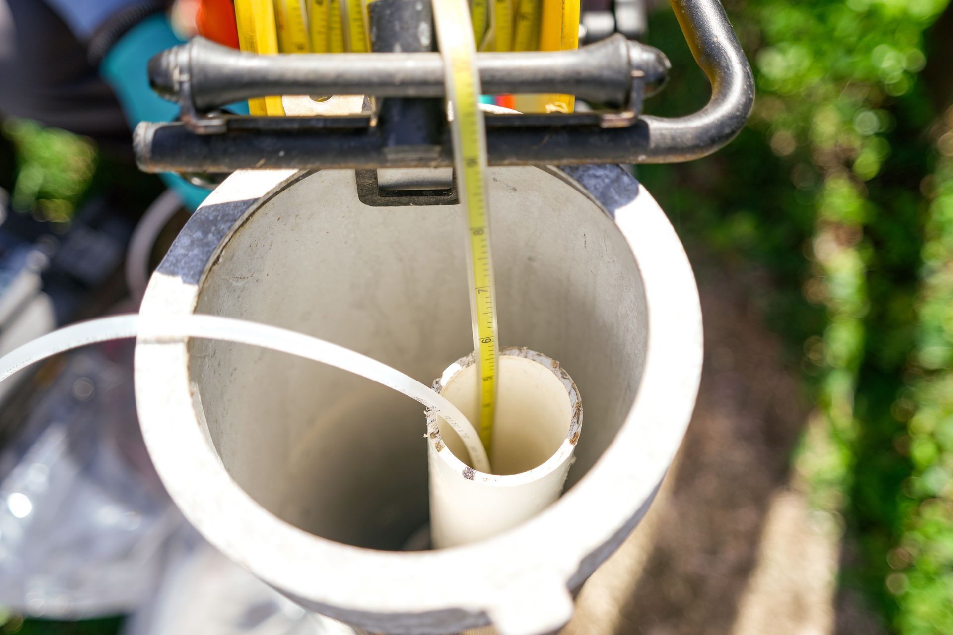 Looking down into a deep, circular well with ropes and a bucket visible.