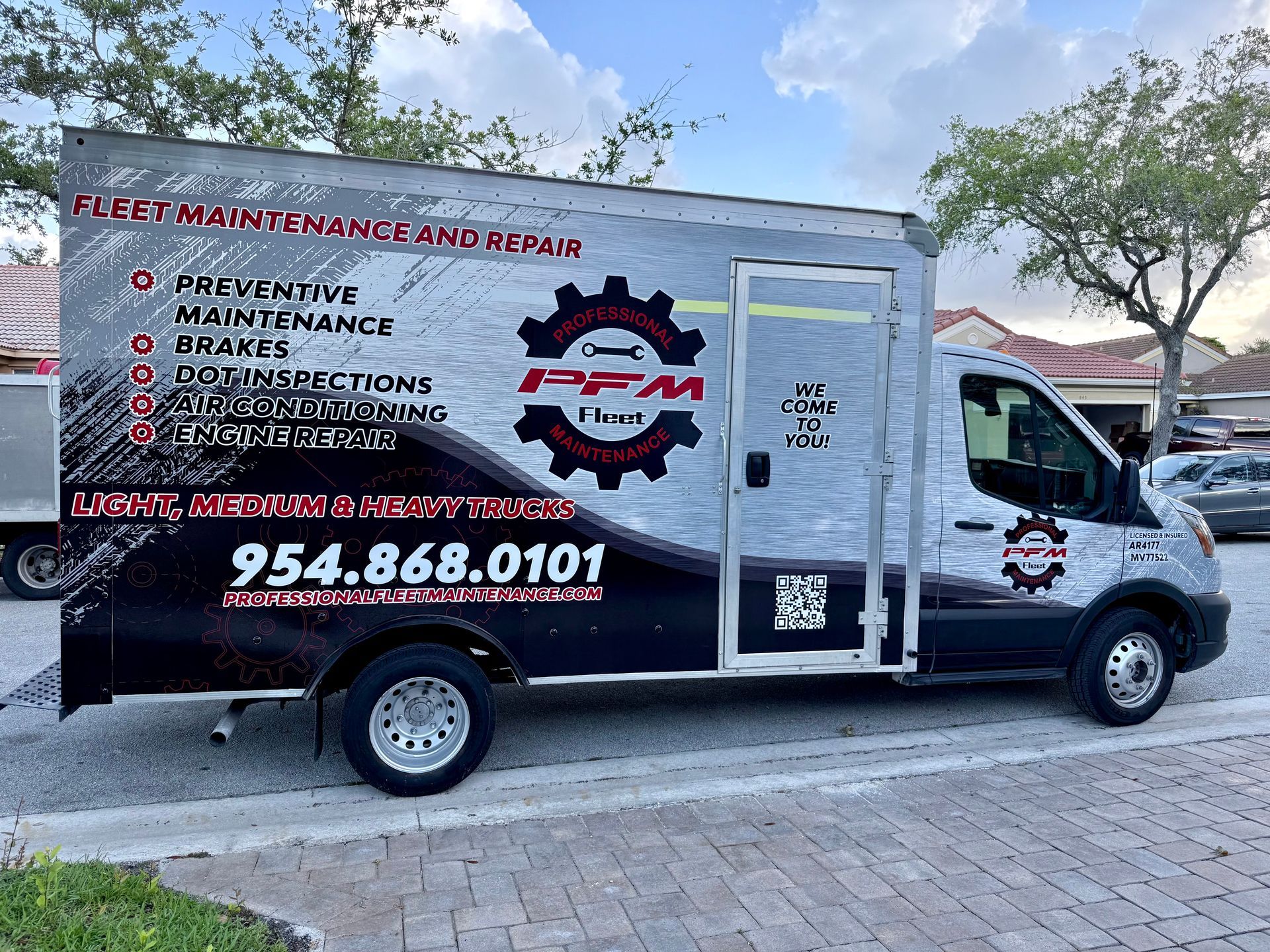 Fleet maintenance truck with logo and contact info.
