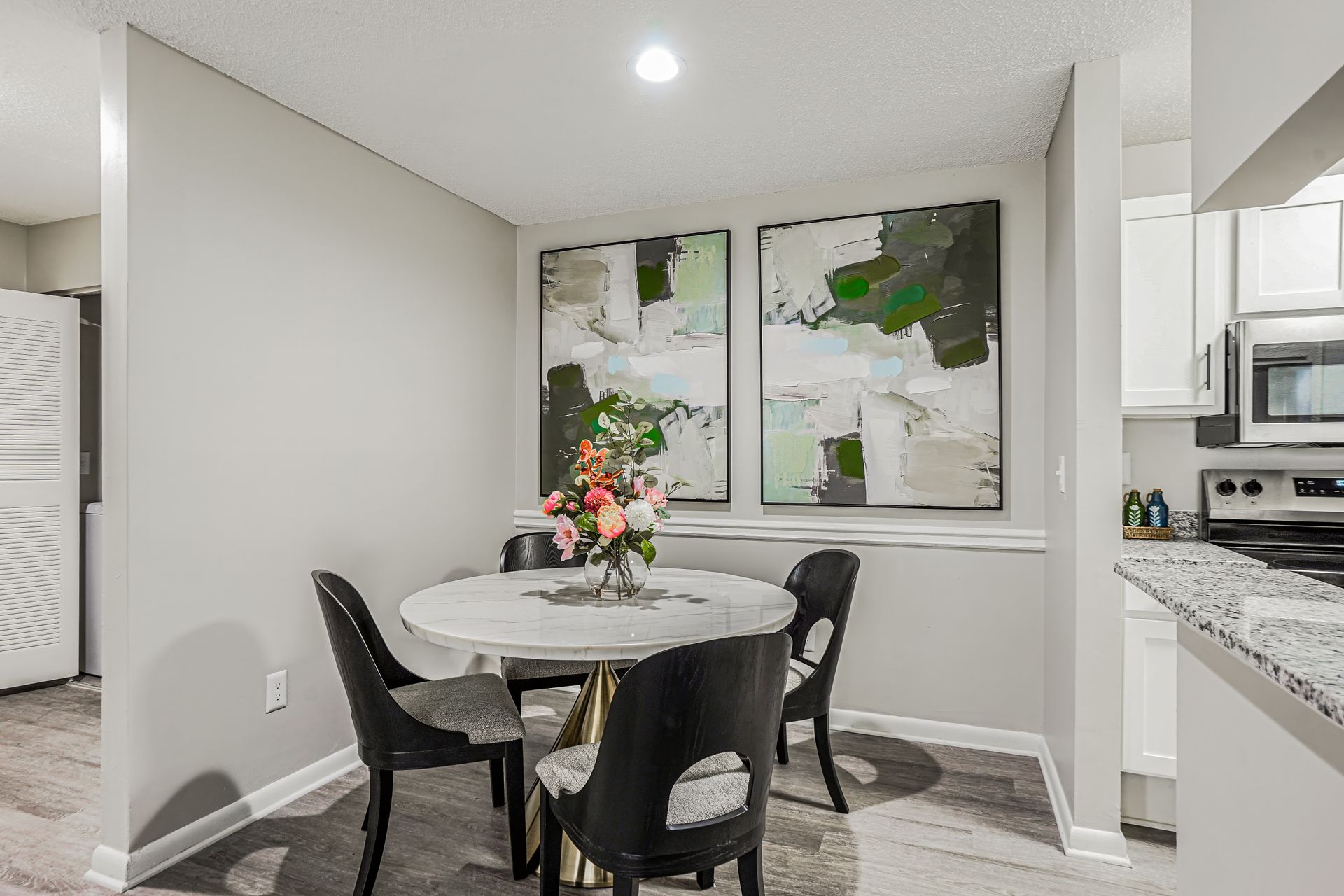 Playground with a slide, and climbing structure, surrounded by mulch and a retaining border, apartments in the background.