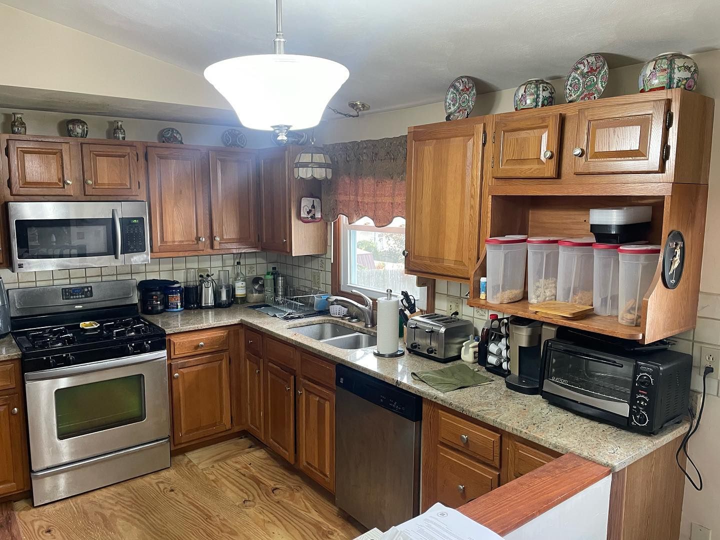 Kitchen with wooden cabinets, stainless steel appliances, and a light-colored countertop.