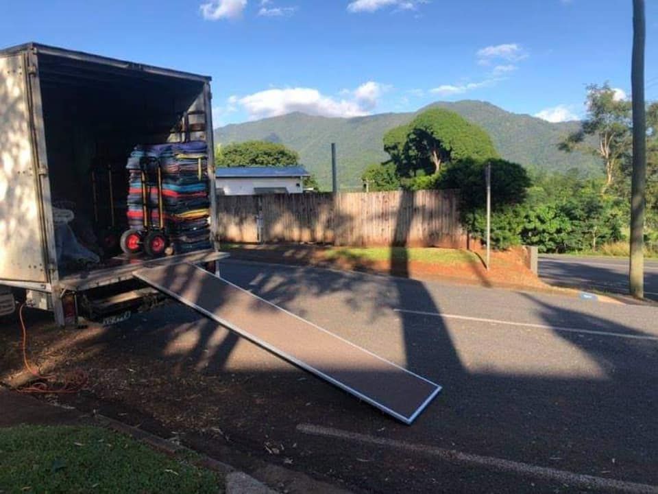 A Moving Truck is Parked on the Side of the Road Next to a Ramp — FNQ Furniture Removals in Mission Beach, QLD