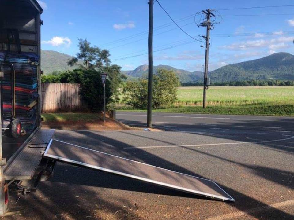 Two Men Are Loading a Couch Into a Van — FNQ Furniture Removals in Mareeba, QLD