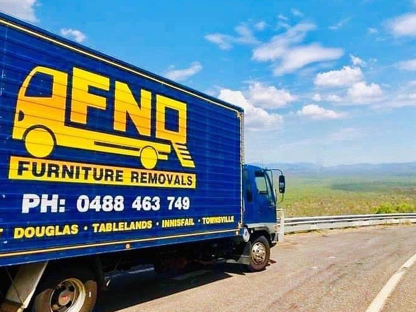 A White Semi Truck is Driving Down a Highway at Sunset — FNQ Furniture Removals in Stratford, QLD