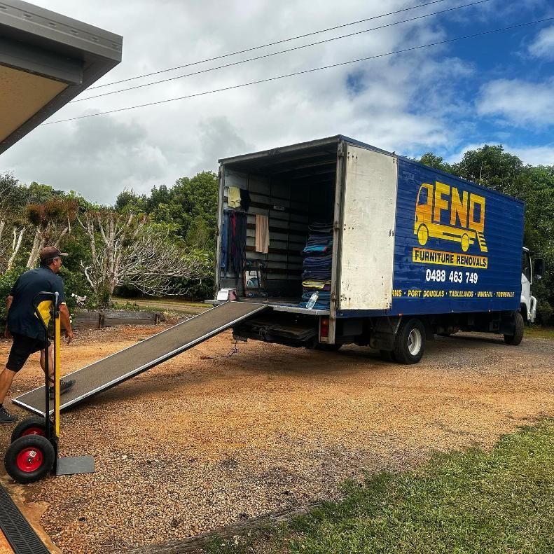 Man Standing On The Back Of Truck — FNQ Furniture Removals in Ingham, QLD