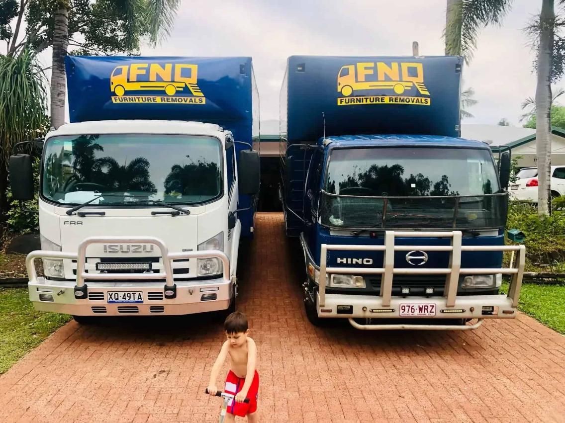 The chairs are wrapped in plastic and the boxes are stacked on the floor — FNQ Furniture Removals in Atherton, QLD