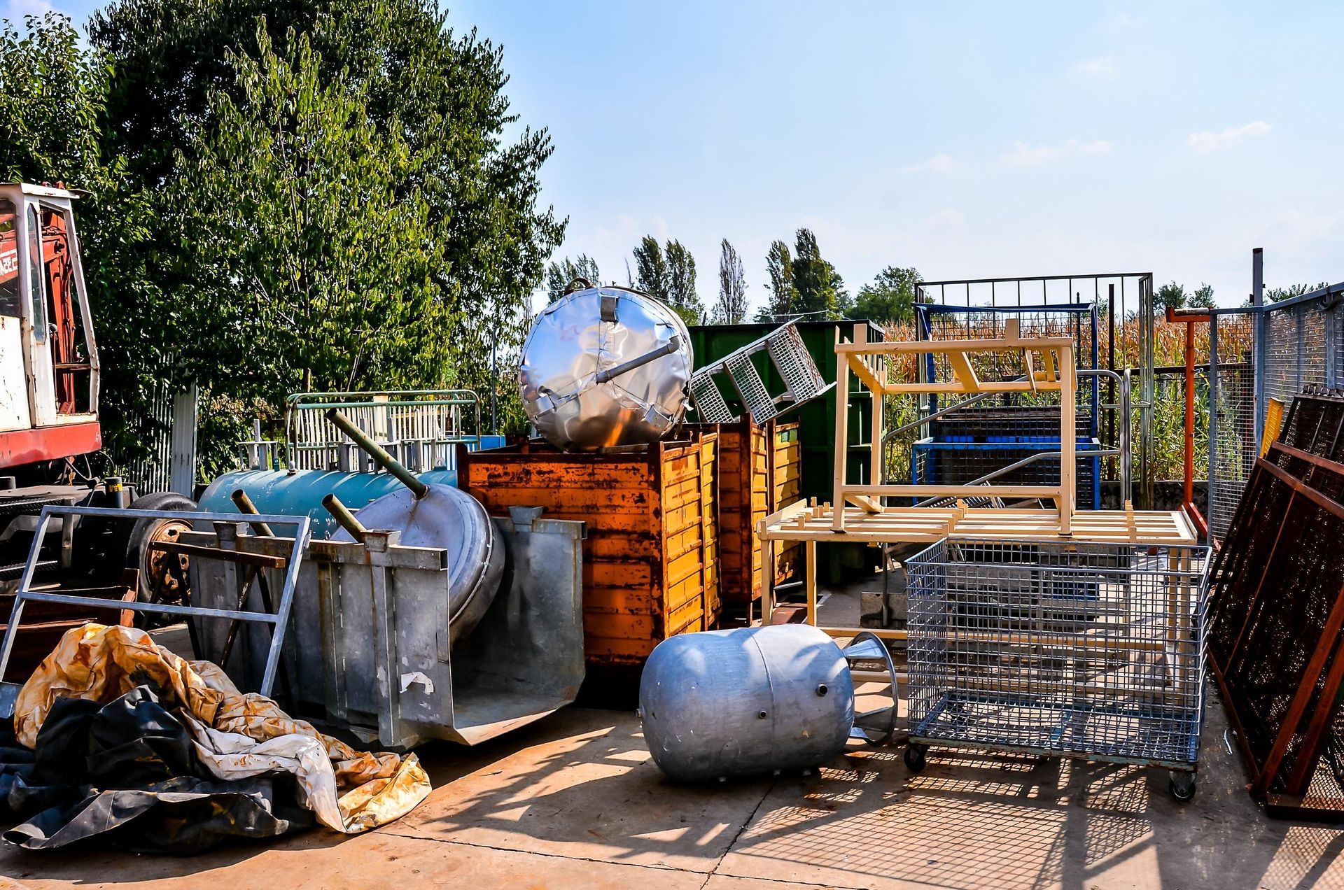 A bunch of containers are stacked on top of each other in a yard