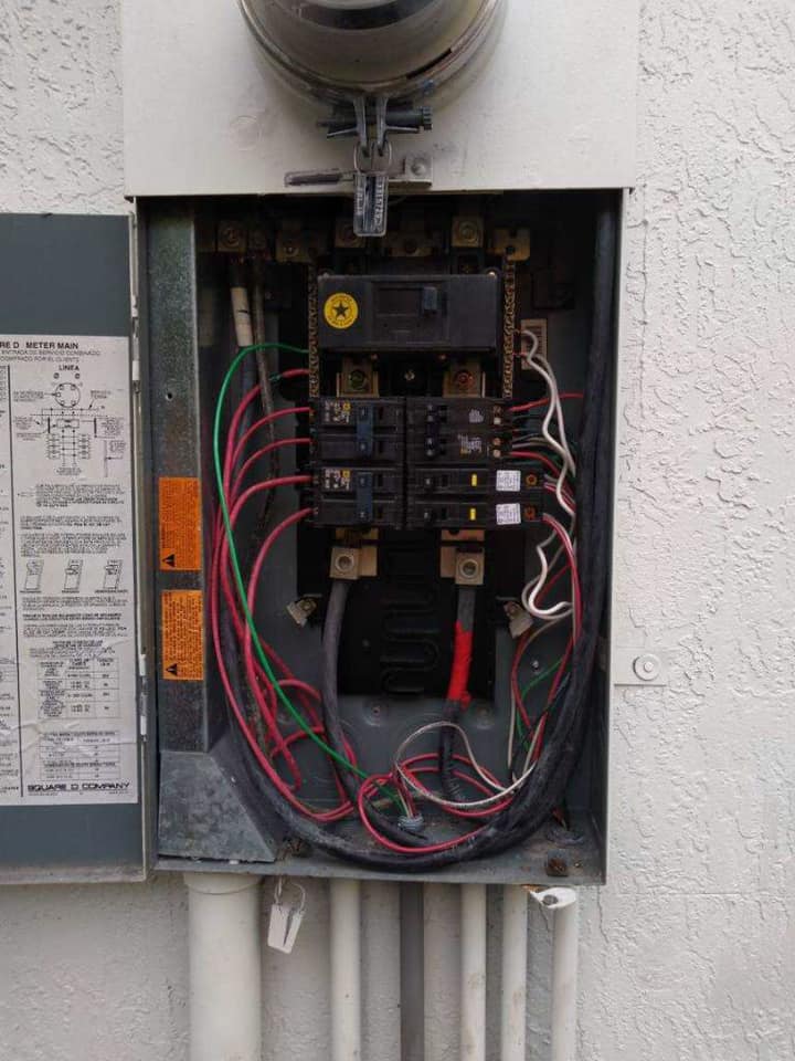 A electrical box with a lot of wires coming out of it.