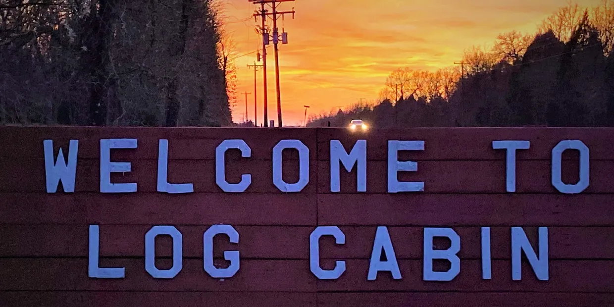 photo of welcome to log cabin sign