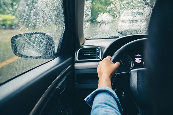 Man Driving A Car During Rain — Owensboro, KY — Cambron Body Shop