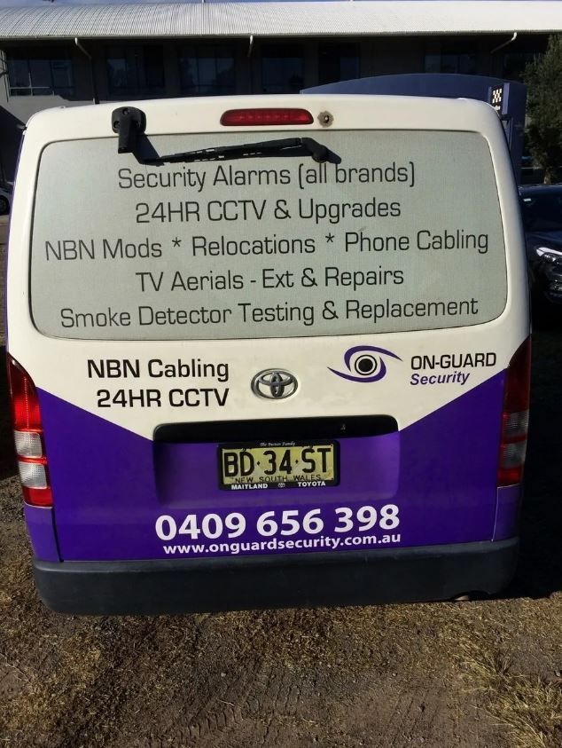 A Living Room With A Couch, Chair, And Paintings On The Wall — St. John Imagery In Kincumber, NSW