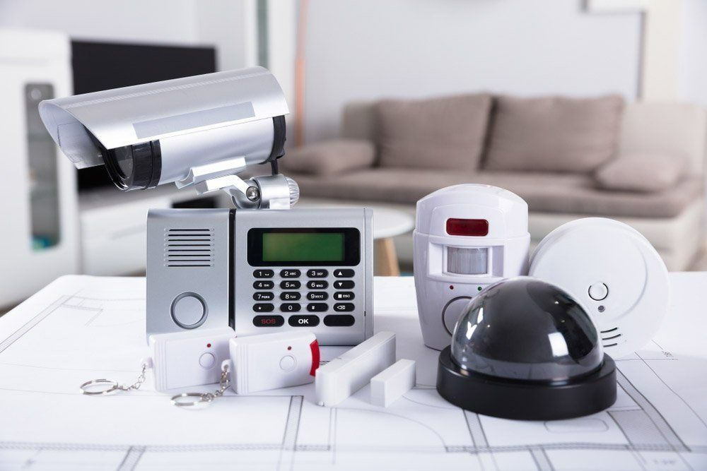 A Security System Is Sitting On A Table In A Living Room — On Guard Security & Communications In Wallsend, NSW