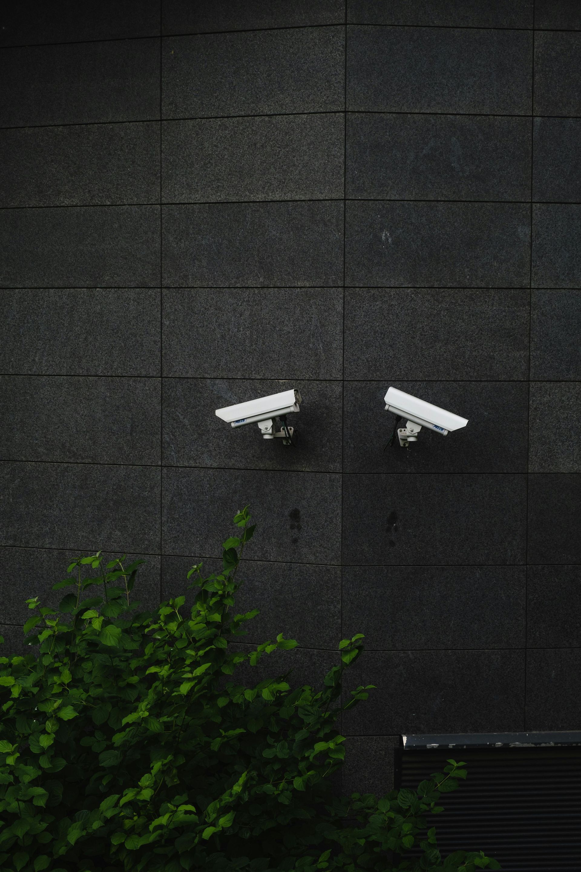 A Group Of Security Cameras And Sensors Are Sitting On Top Of A Blueprint — On Guard Security & Communications In Wallsend, NSW