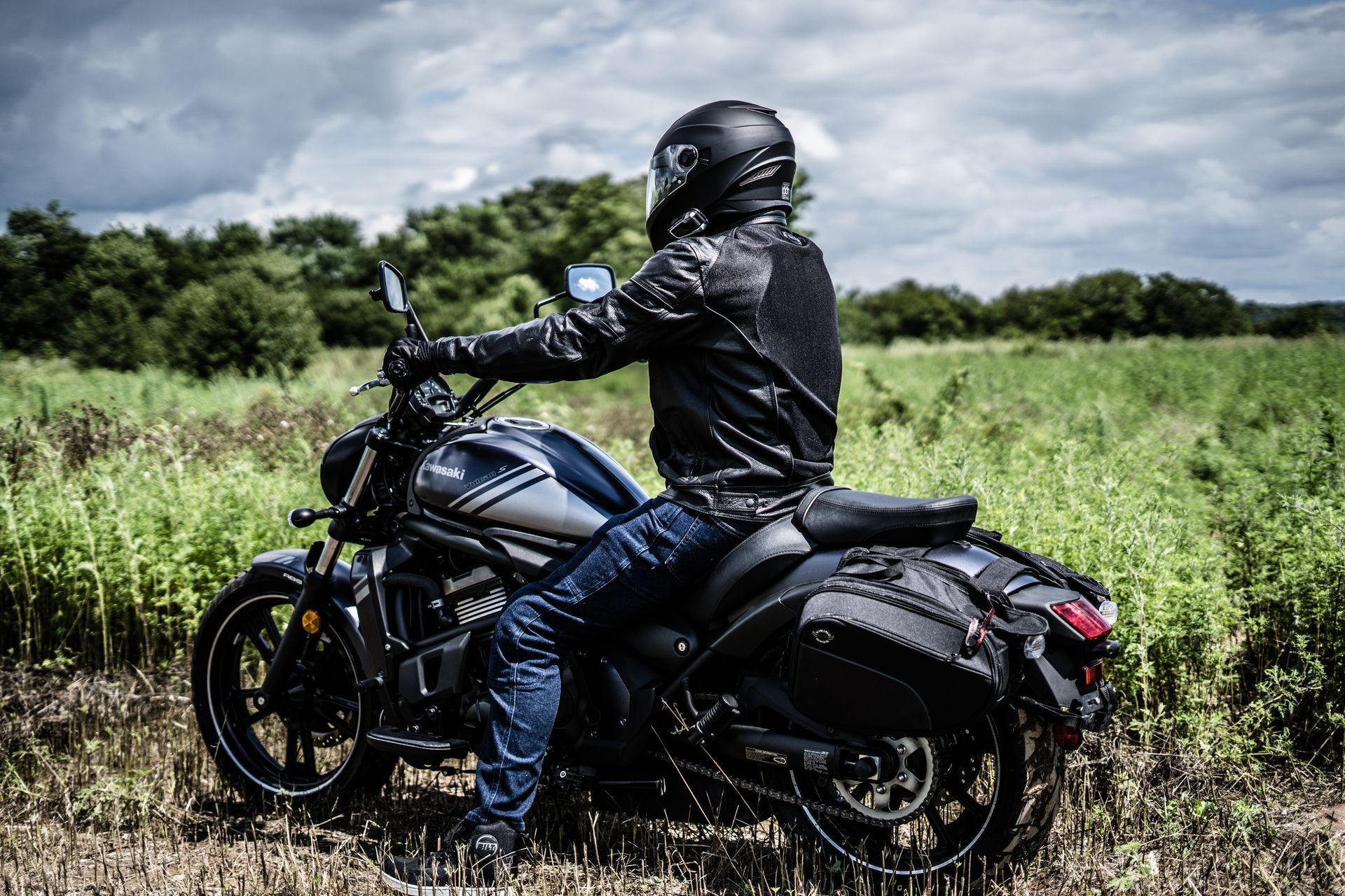A man is riding a motorcycle in a field.