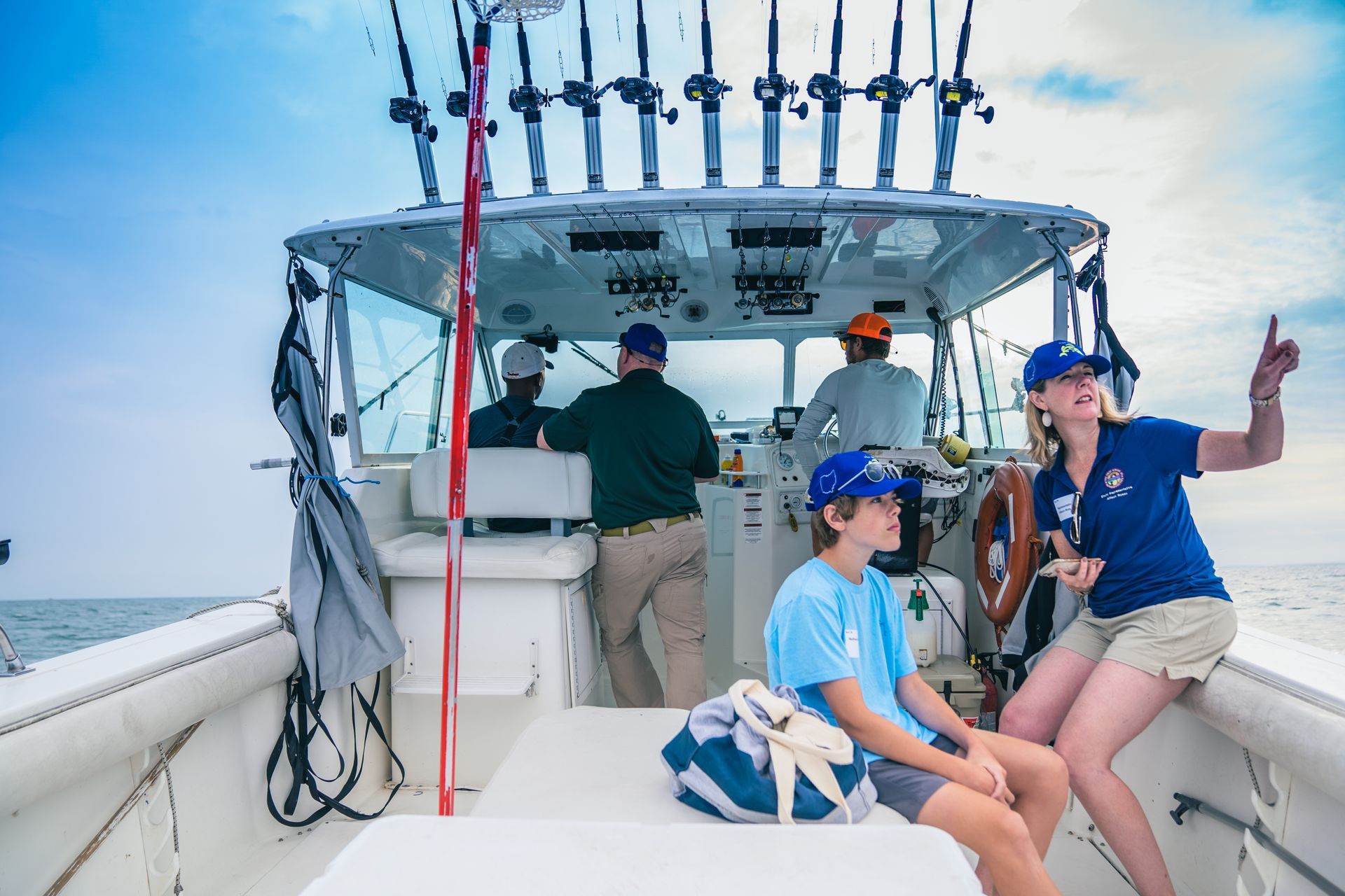 A group of people are sitting on a boat in the ocean.
