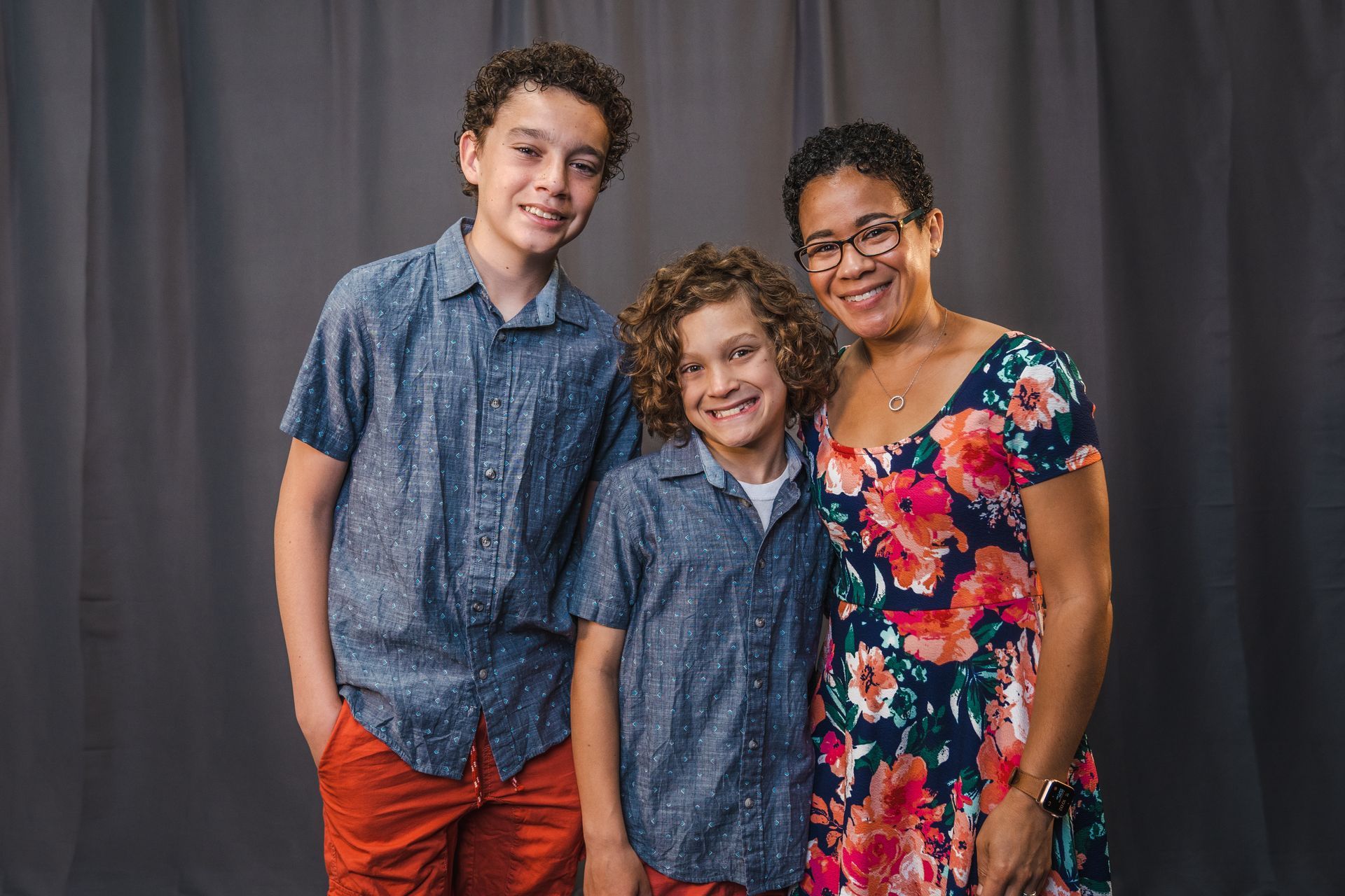 A woman and two children are posing for a picture.