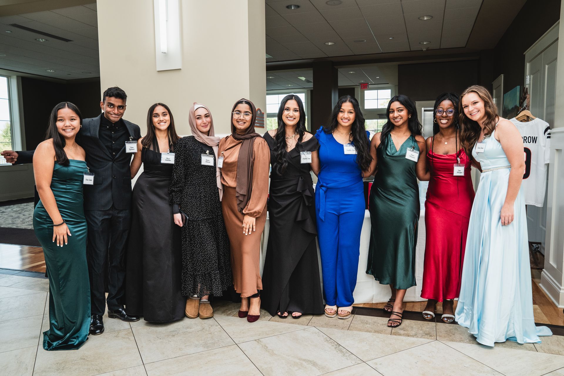 A group of people are posing for a picture together in a room.