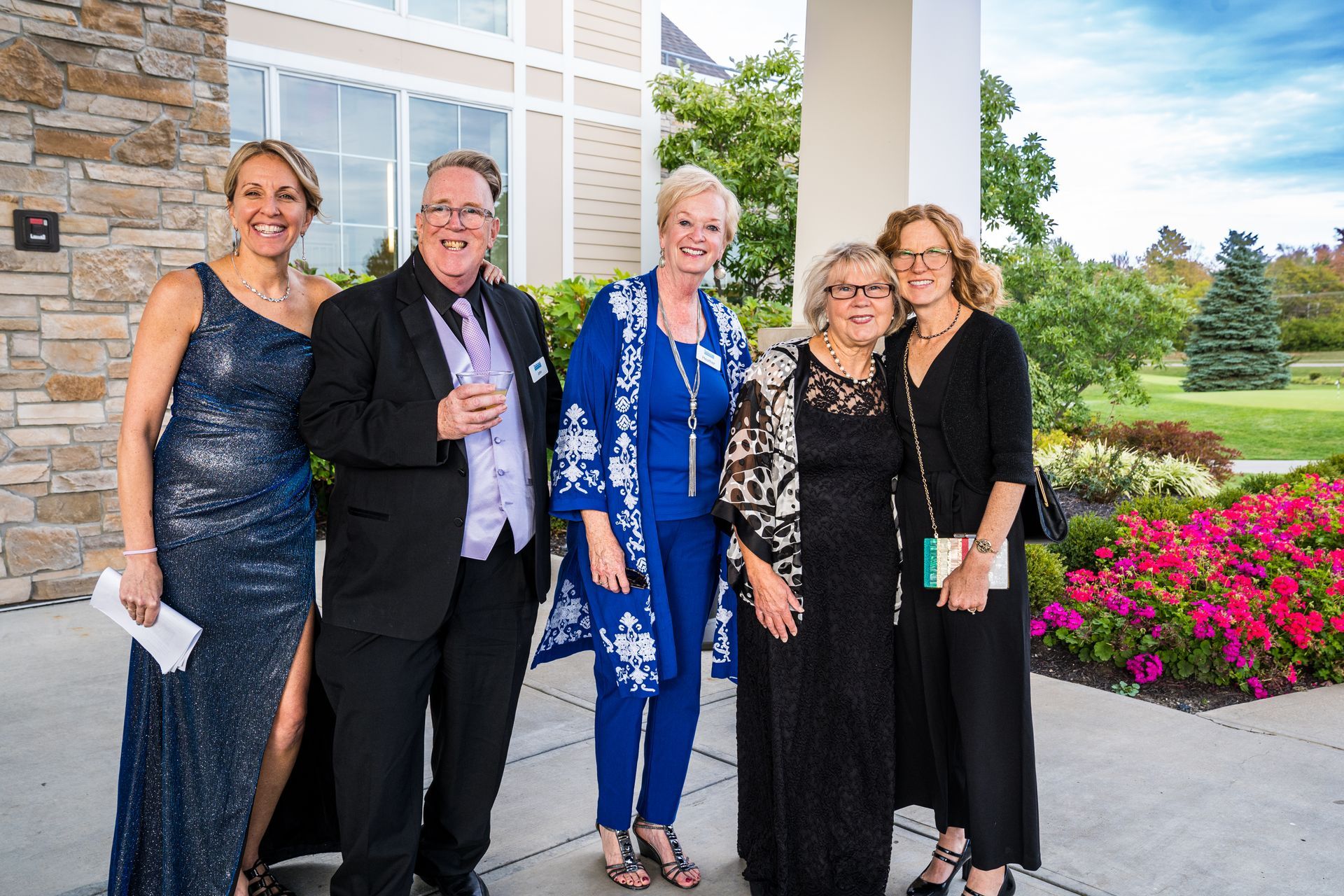 A group of people are posing for a picture in front of a building.