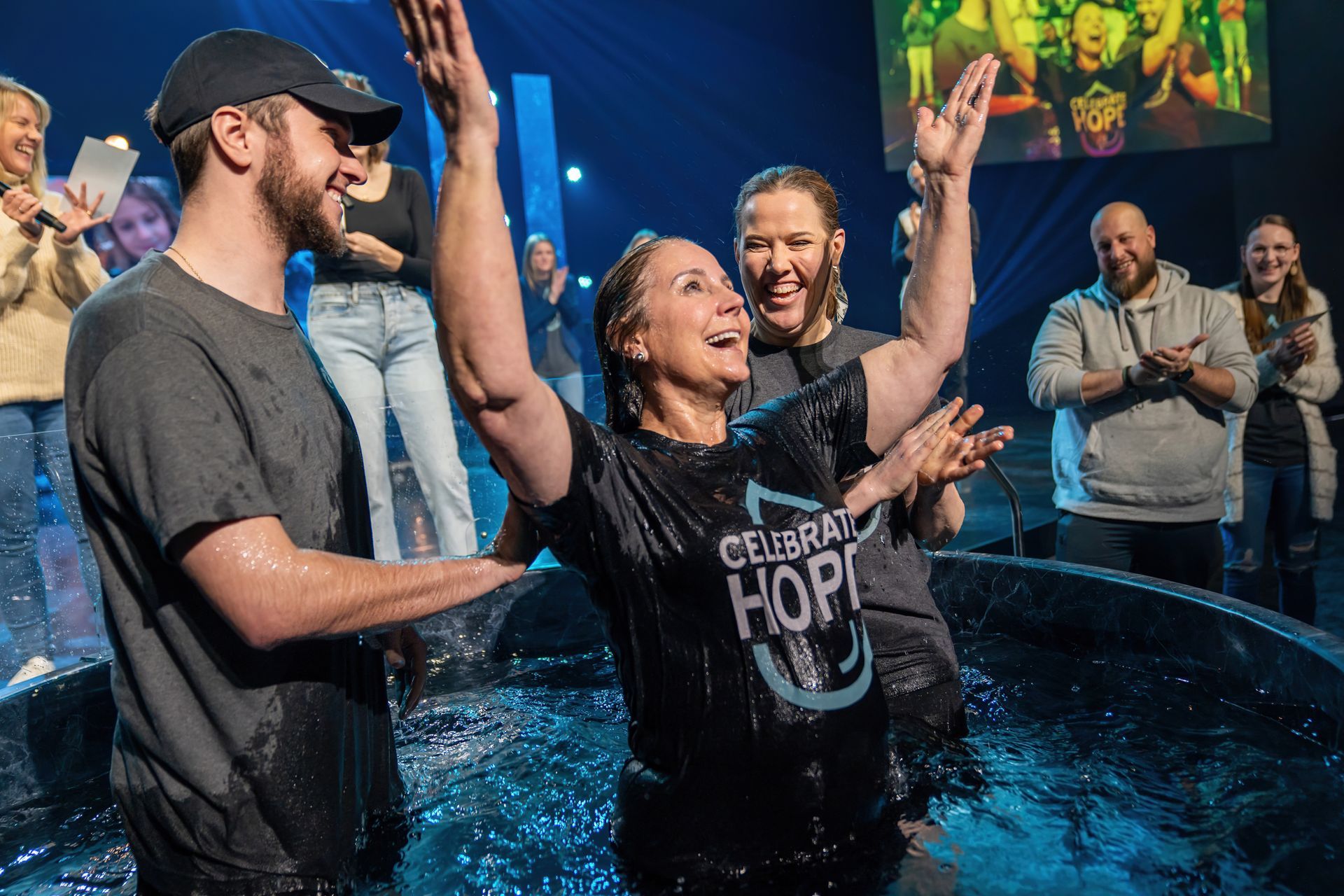 A woman is being baptized by a group of people in a church.