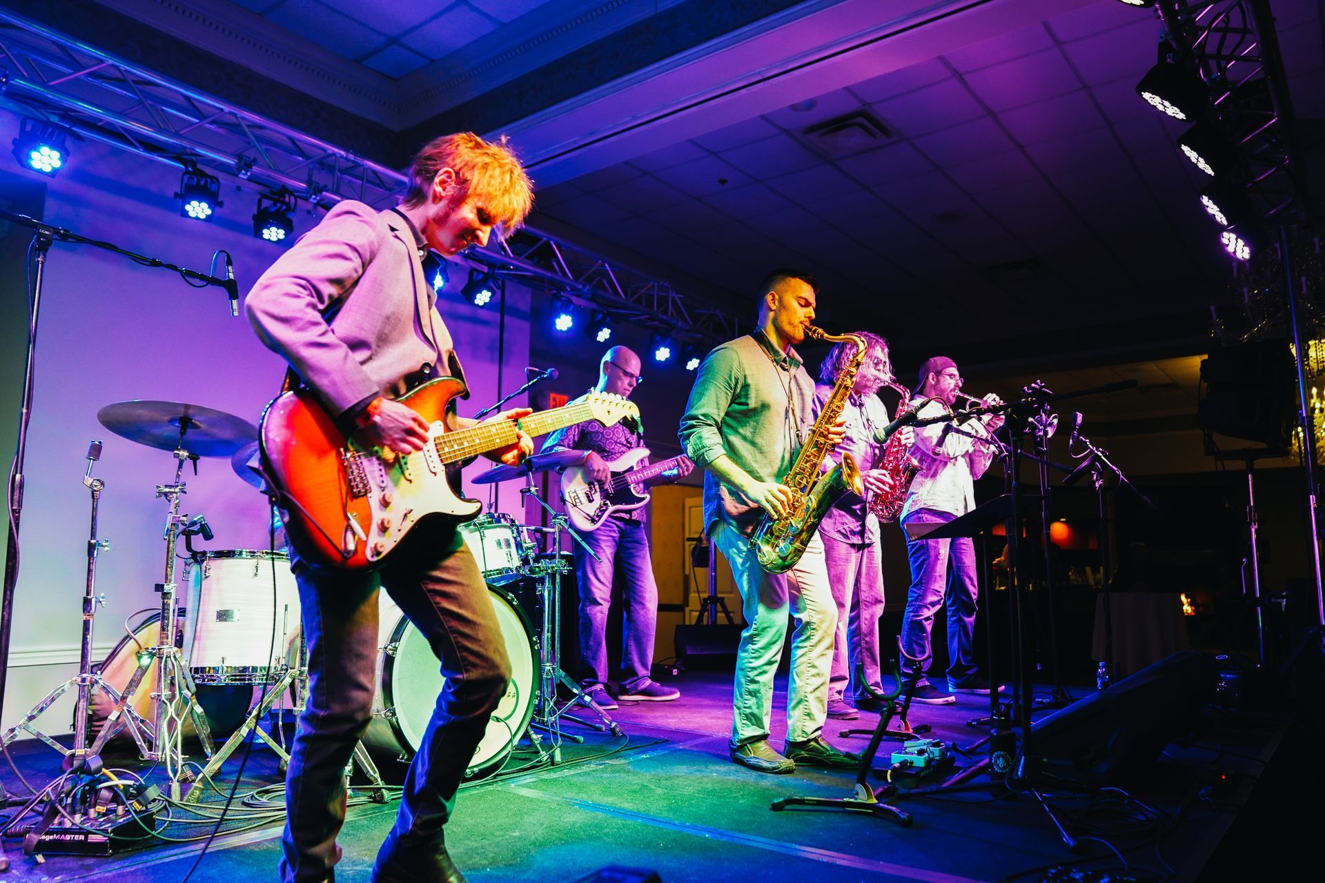A group of people are playing instruments on a stage.