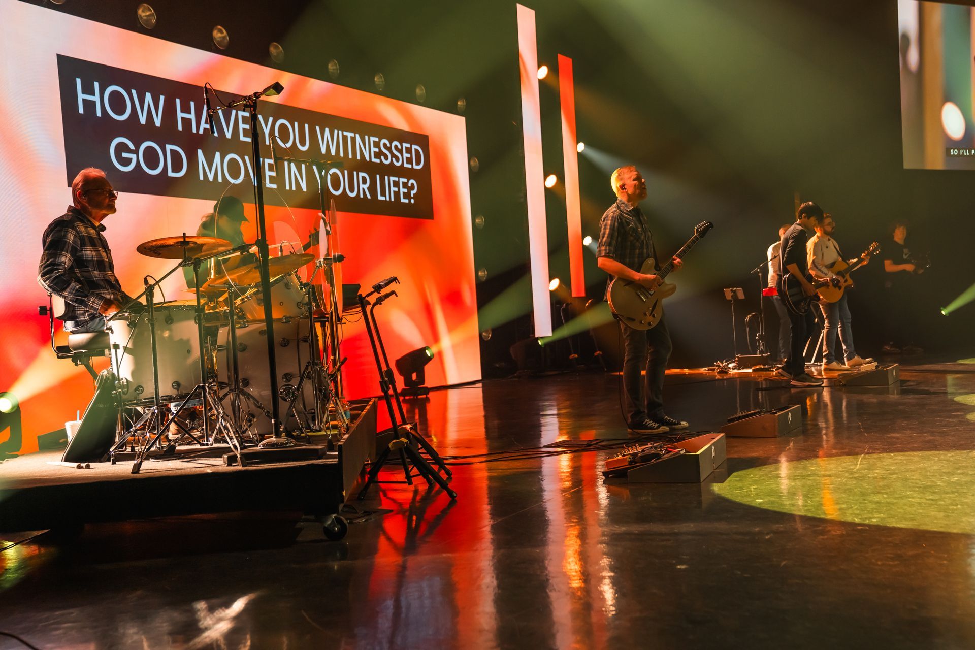 A group of people are playing instruments on a stage