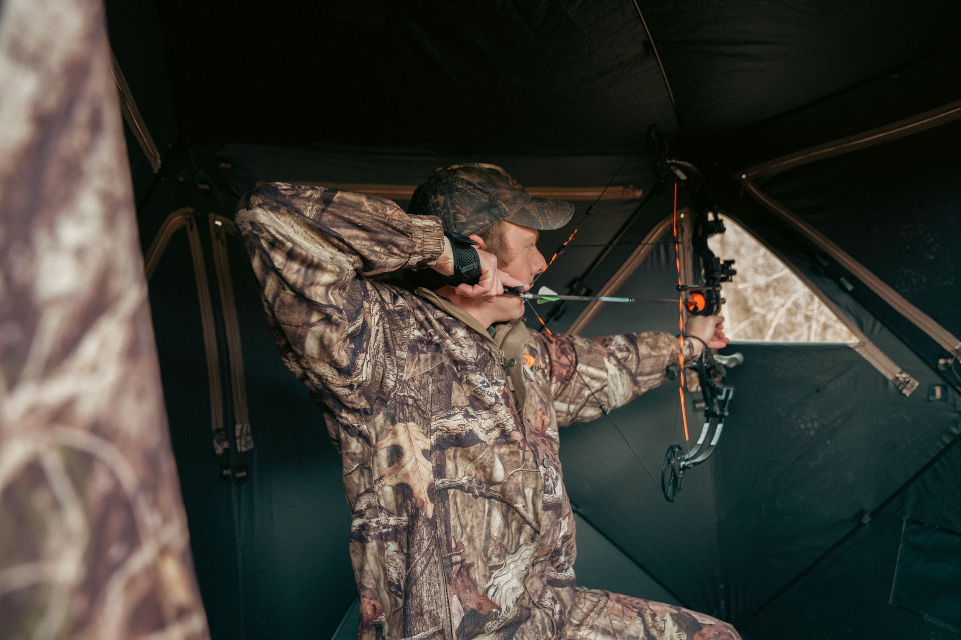 Man shooting bow in camoflauge