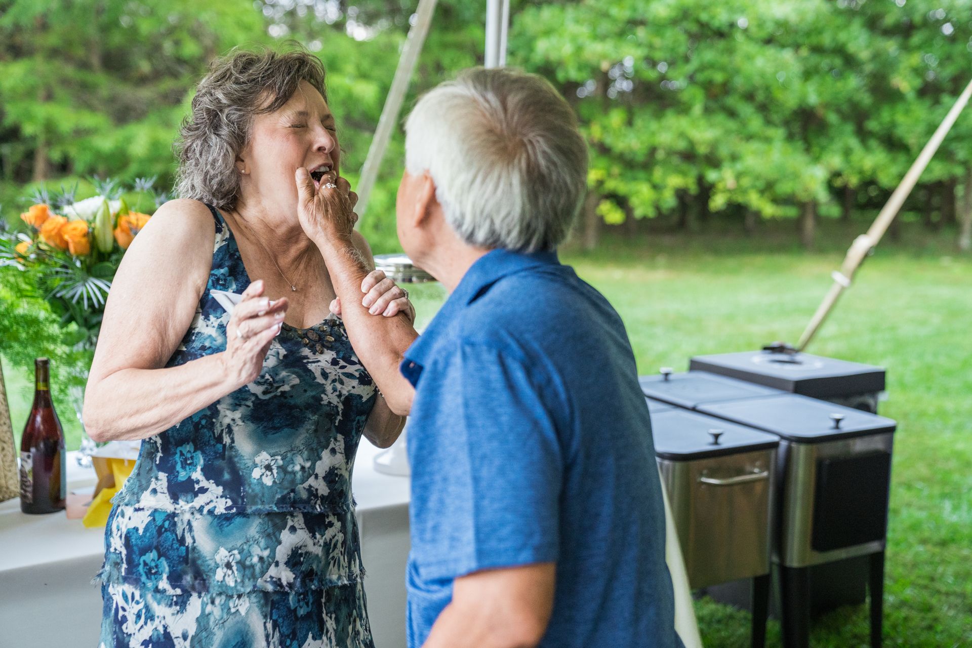 A man and a woman are dancing together in a tent.